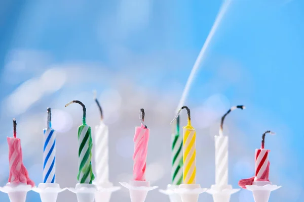 colorful birthday candles on blue background
