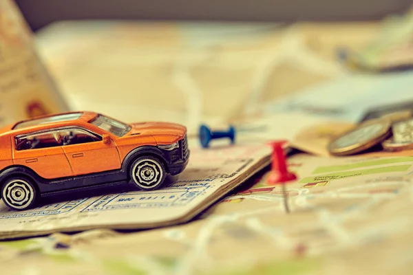 small toy car on map, travel concept