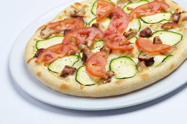 tasty pizza with zucchini on white plate, close-up