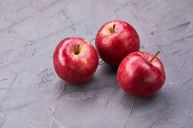 fresh apples on grey background, close view 