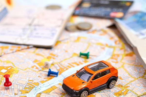 small toy car on map, travel concept