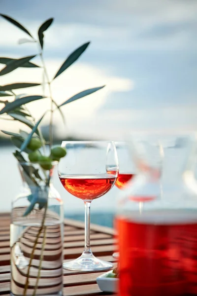 Dos Copas Vino Rosas Con Aceitunas Contra Agua Azul Muelle —  Fotos de Stock