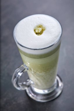  Ketogenic keto diyet sıcak içecek. Hindistan cevizi yağı ve tereyağıyla harmanlanmış gri arka planda çay eşleşmesi, yakın görüş