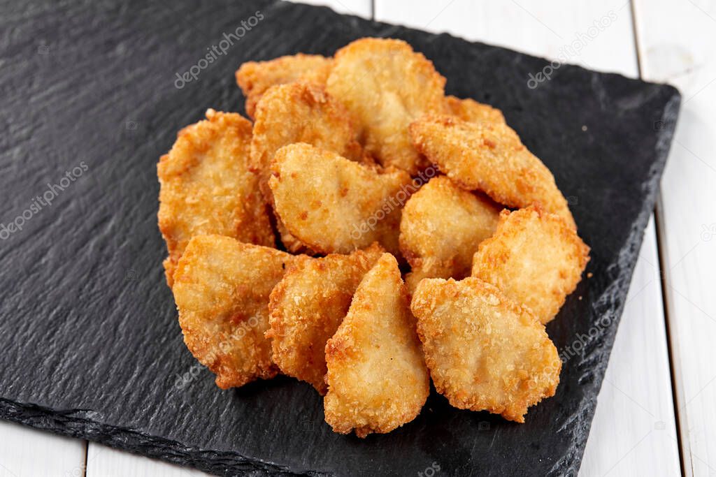 chicken nuggets on board, close view 