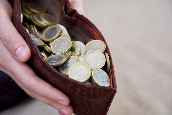 man hand holding purse with money, closeup