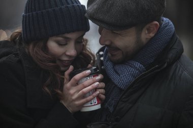 Sevgi dolu çift, içme kahve, açık havada, kentsel twilight saat