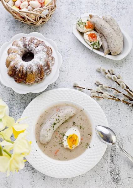 Easter breakfast. Sour rye soup with eggs and sausage — Stock Photo, Image