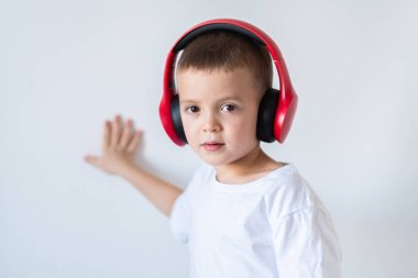 Boy in white t-shirt with headphones isolated on white background