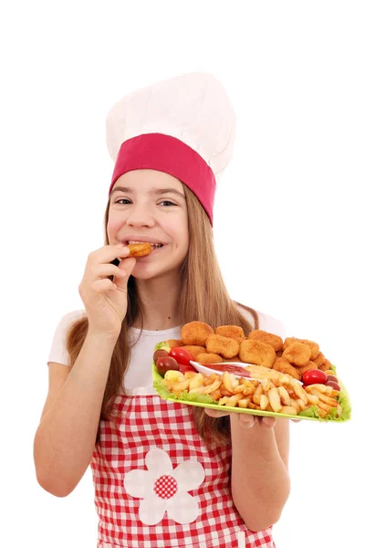 Girl cook eats chicken nuggets fast food — Stock Photo, Image