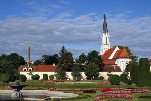 Kościół i park z kwiatami i fontanną w Wiedeń Austria — Zdjęcie stockowe