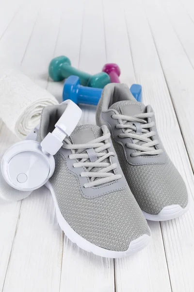 Sport Symbols Gray Sneakers Earphones Towel Dumbbells White Table — Stock Photo, Image