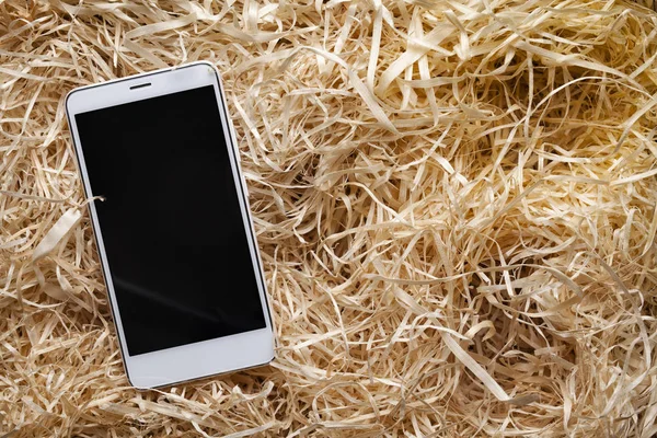 White Modern Smartphone Box Full Wood Shavings — Stock Photo, Image