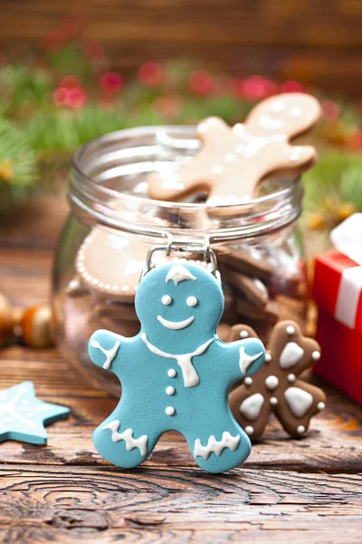 Colorful Christmas cookies in a jar and wooden table