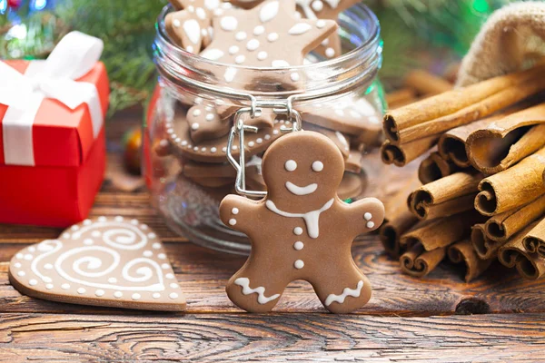 Gingerbread Christmas cookies, gift box and spices on wooden table