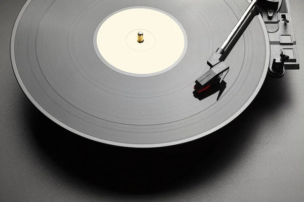 Black vinyl record player on black table background — Stock Photo, Image