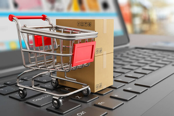 Online shopping mail order symbol - shopping trolley cart and cardboard shipping boxes on laptop keyboard - 3d illustration