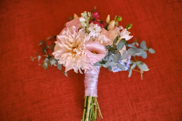 Wedding bouquet on a red background, wedding details