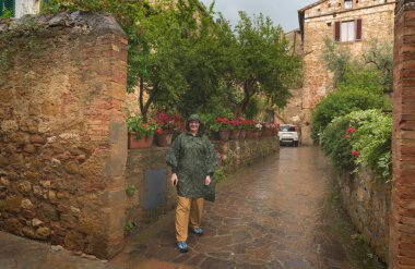 Su geçirmez ceket eski kasabadan Pienza, Toskana yürüyüş genç kadın. İtalya
