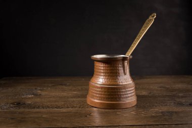 Ahşap masa üzerinde Türk bakır tencerede sıcak kahve