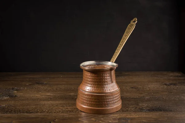 木桌上土耳其铜锅中的热咖啡 — 图库照片