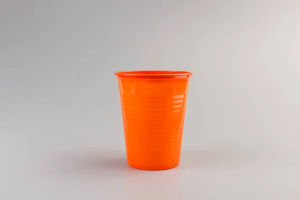 Orange Plastic Cup Isolated Grey Background — Stock Photo, Image