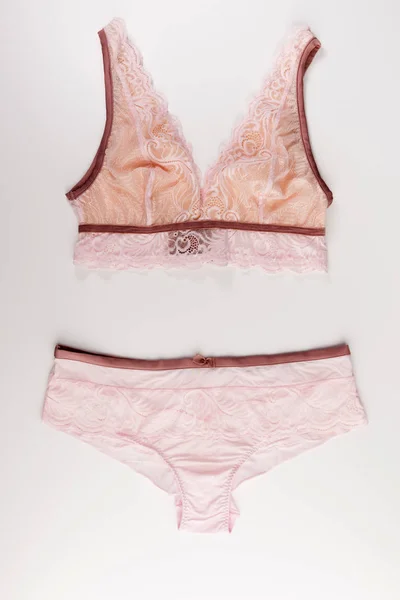 pink lace tender lingerie set isolated on a white background, top view