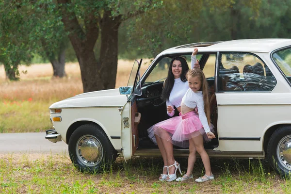 Happy family on a road trip in their car. Mom and daughter are traveling by car. Summer ride by automobile