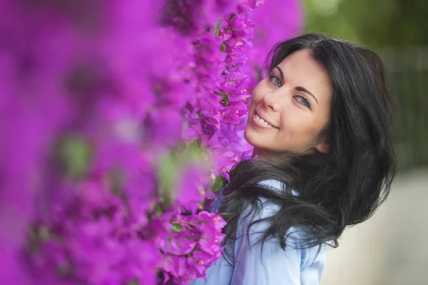 花に囲まれた美しい若い女性の屋外ファッション写真 春の花 — ストック写真