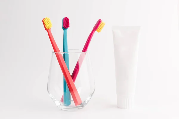 Toothbrushes Glass Isolated Pink Background Toothpaste Tube — Stock Photo, Image