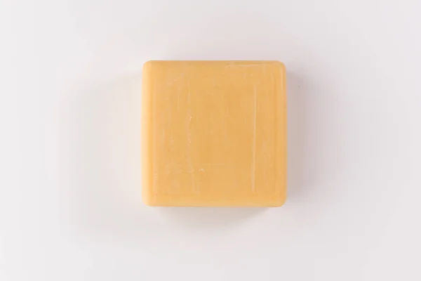 一块米色肥皂隔离在白色的背景 顶部视图 — 图库照片
