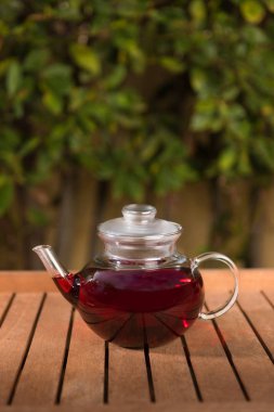 Ahşap masa açık havada gibiscus çay çaydanlık