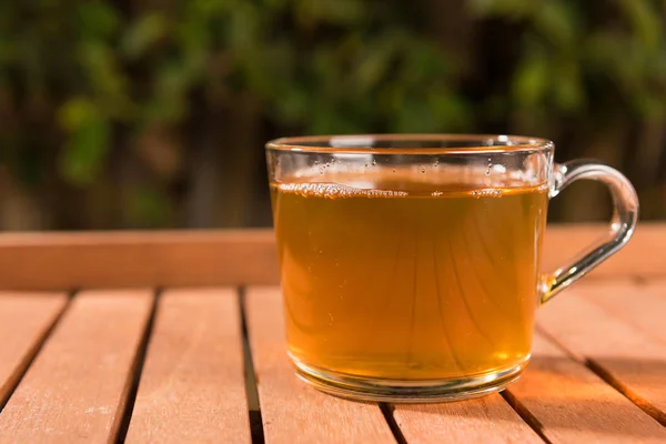 屋外の木製のテーブルの緑茶のカップ — ストック写真