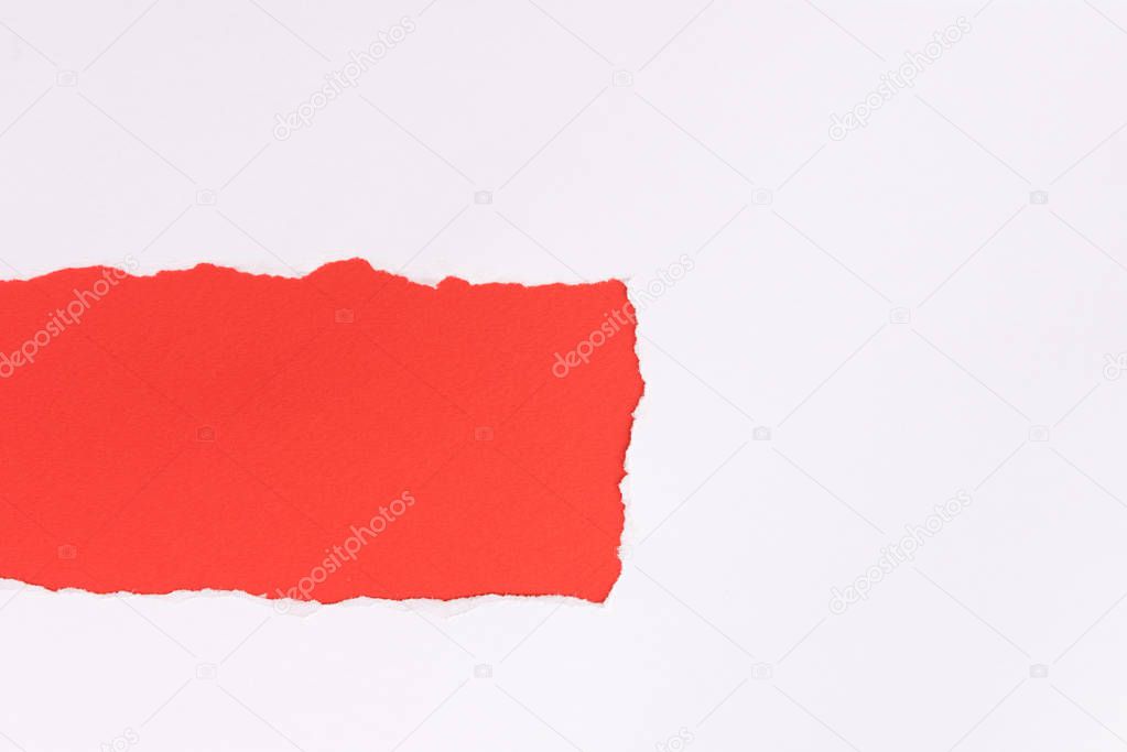 White torn paper over red background