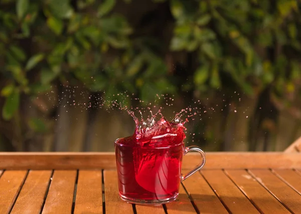 Tea splash in the cup. Splash outdoor. Splash in the cup