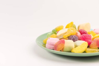 Beyaz bir arka plan üzerinde izole tatlılar ile Plaka. Sakızlı şekerler ve marshmallow.