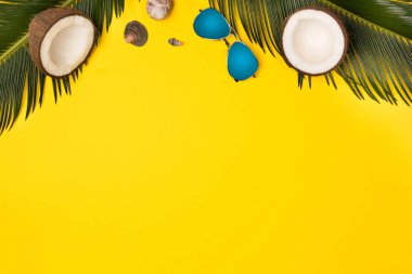 Mavi pastel renk arka plan üzerinde hindistan cevizi, güneş gözlüğü ve deniz kabukları şapka ile Yaratıcı Düz yatıyordu moda tarzı