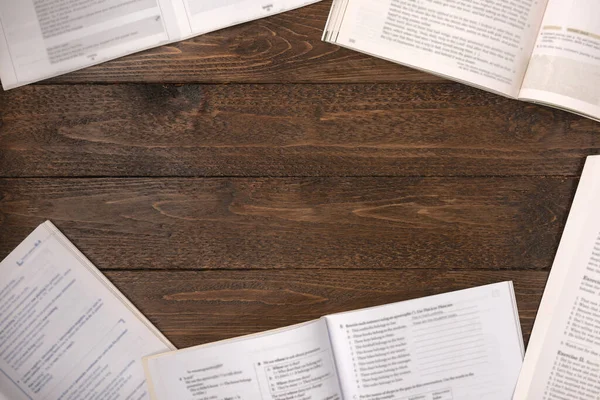 Remote education concept. Open books on wooden desk, flat lay