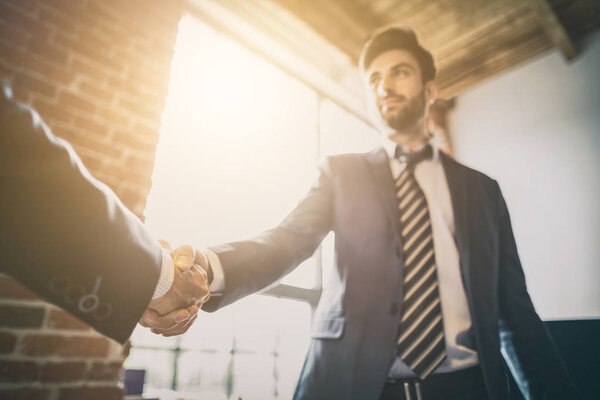 Business people shaking hands, finishing up meeting. Successful businessmen handshaking after good deal.