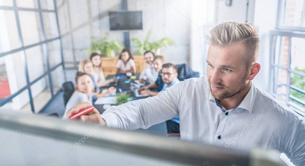 Business coach. Team leader teaches employees at a business meeting in a conference room.