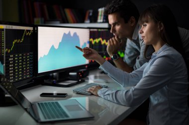 adam ve kadın ofiste bilgisayar ekranında arıyor