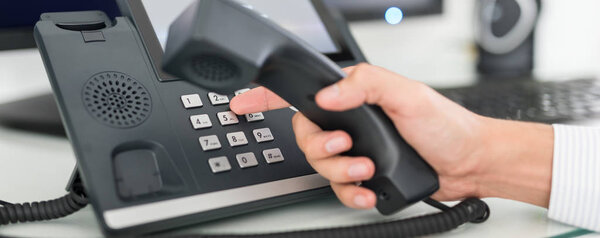 Communication support, call center customer service help desk. Using telephone keypad. 