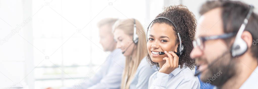 Smiling Call center worker accompanied by her team