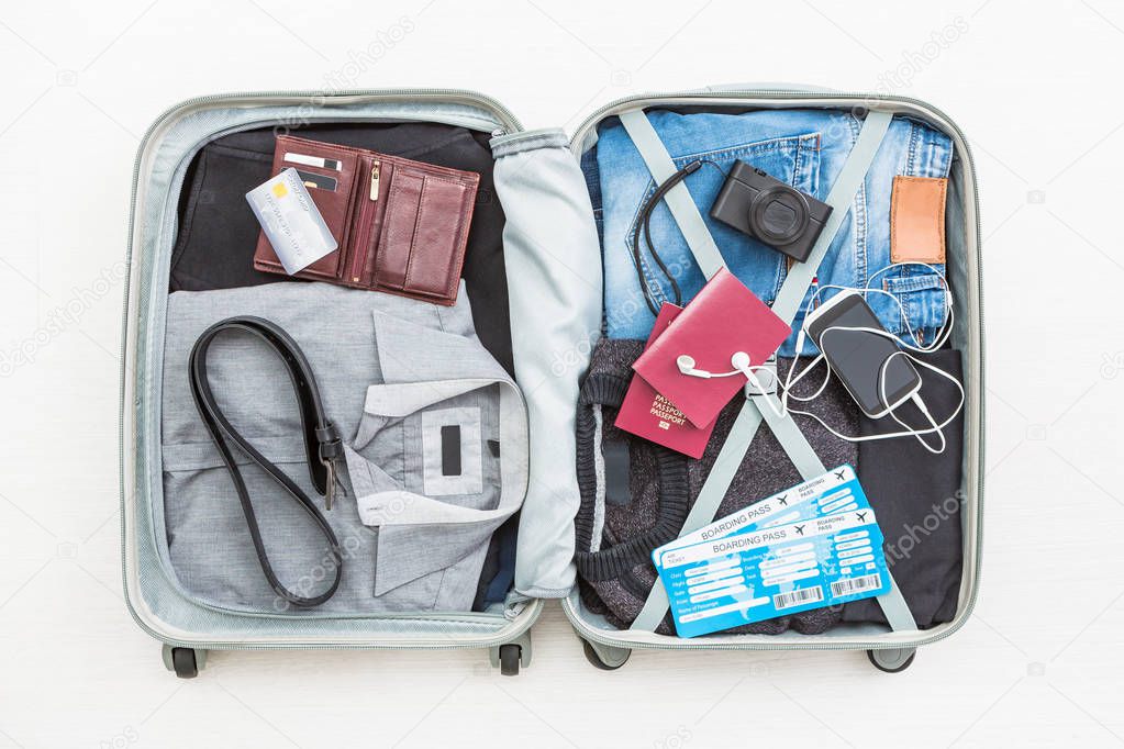 travel traveler traveling bag top open view packing card camera packed credit wallet clothing table leaving departure concept - stock image