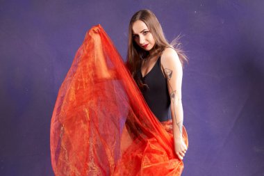 Turuncu kuşakla dans eden hoş ve formda bir kız..                                        