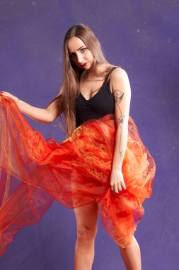 Turuncu kuşakla dans eden hoş ve formda bir kız..                                        