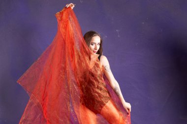 Turuncu kuşakla dans eden hoş ve formda bir kız..                                        