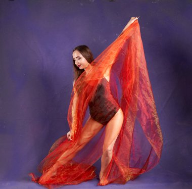 Turuncu kuşakla dans eden hoş ve formda bir kız..                                        