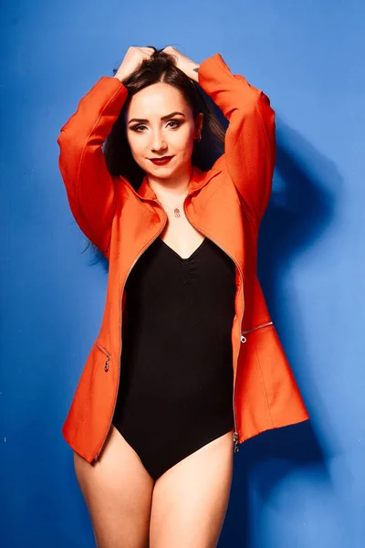 Nice Young White Girl Wearing Black Body Orange Jacket Blue — стоковое фото