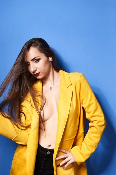 Beautiful Girl Poses Yellow Coat Blue Wall — Stock Photo, Image