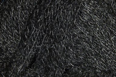 Konu closeup, parlayan tek renkli arka plan veya doku siyah yün reeled